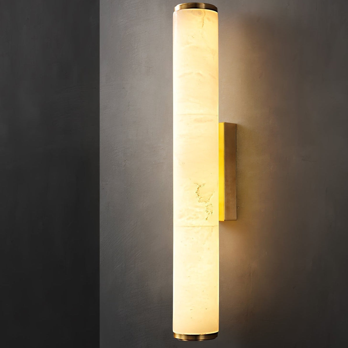 Glowing natural alabaster aerq tube light highlighting its organic stone veining against a dark background