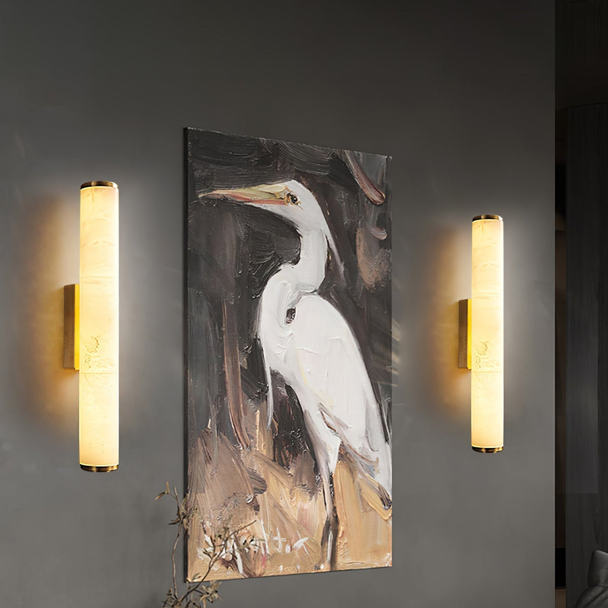 Pair of modern alabaster aerq wall sconces beautifully framing a piece of artwork on a living room wall