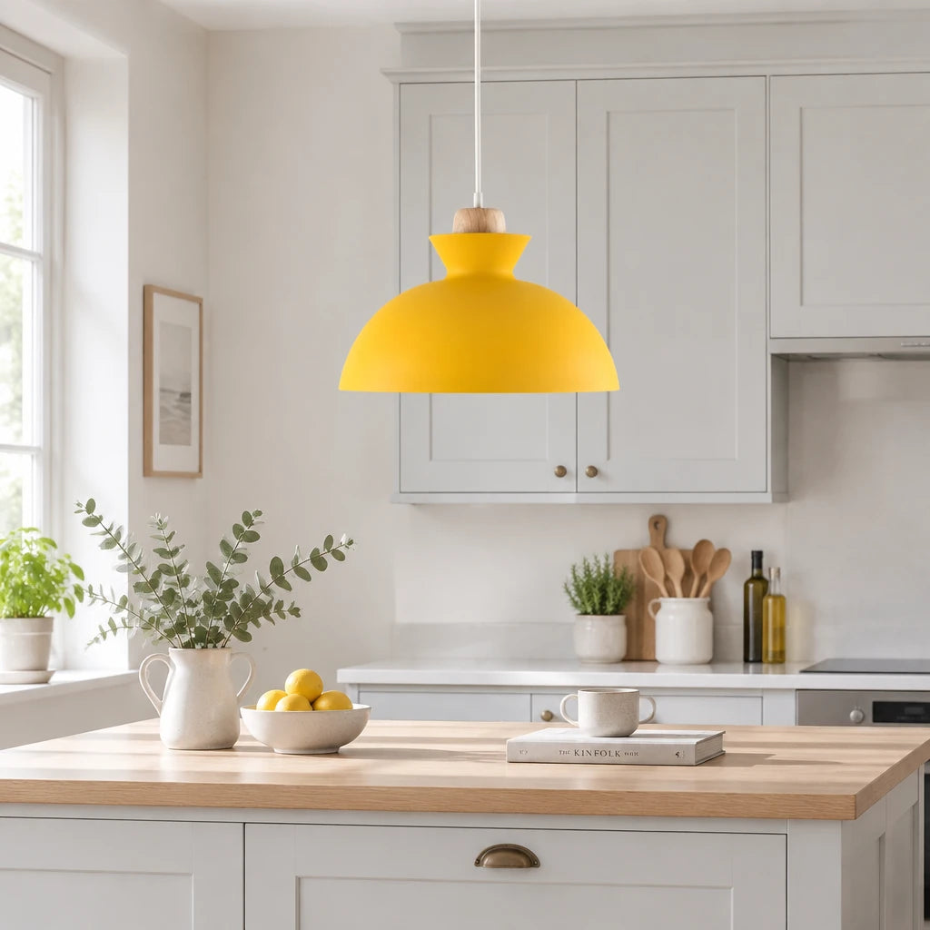 Alken yellow dome pendant light above a kitchen counter in a modern British minimalist home