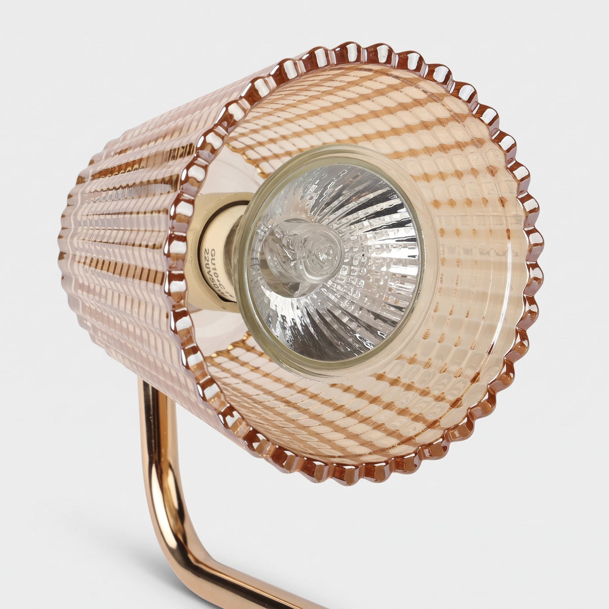 Close-up of the Ambra amber ribbed glass shade with the included bulb on a light grey background