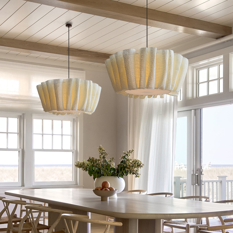 Vintage pleated fabric aqer ceiling lamp casting a warm glow over a bright dining space