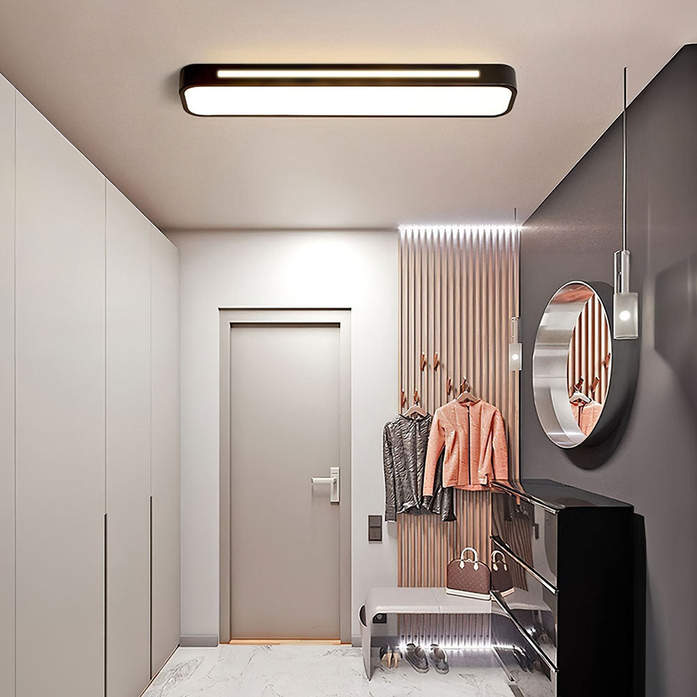 Modern black linear flush mount atio ceiling light providing bright ambient lighting in a sleek corridor