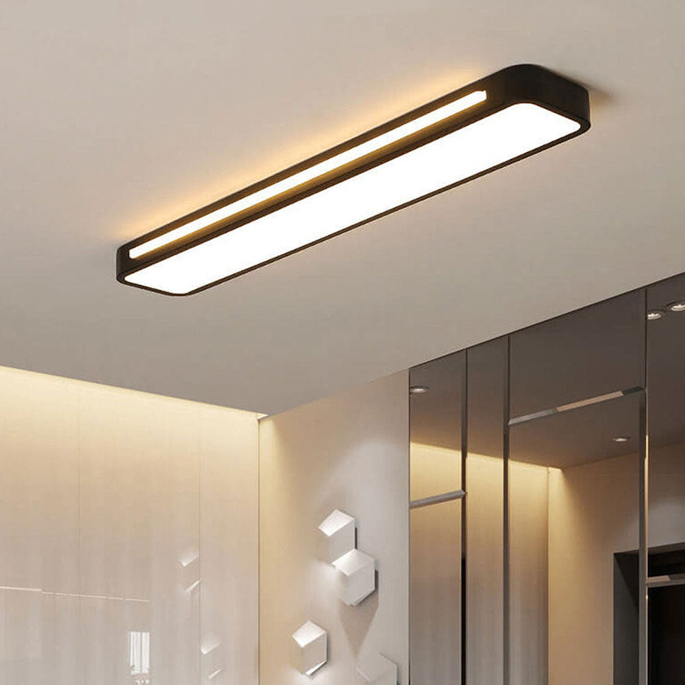 Close-up of an ultra-thin black linear LED atio-ceiling light glowing in a contemporary room