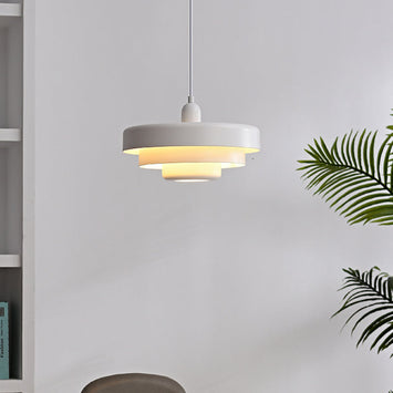 Modern balel white Bauhaus tiered pendant light hanging in a bright contemporary living space