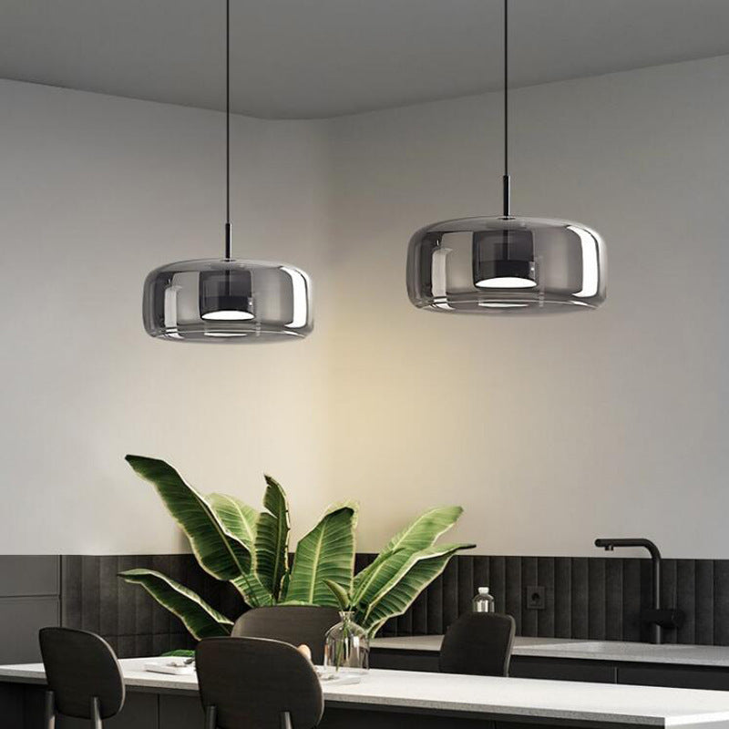 Two wide smoke grey glass beqi pendant lights complementing a sophisticated, dark-toned kitchen island