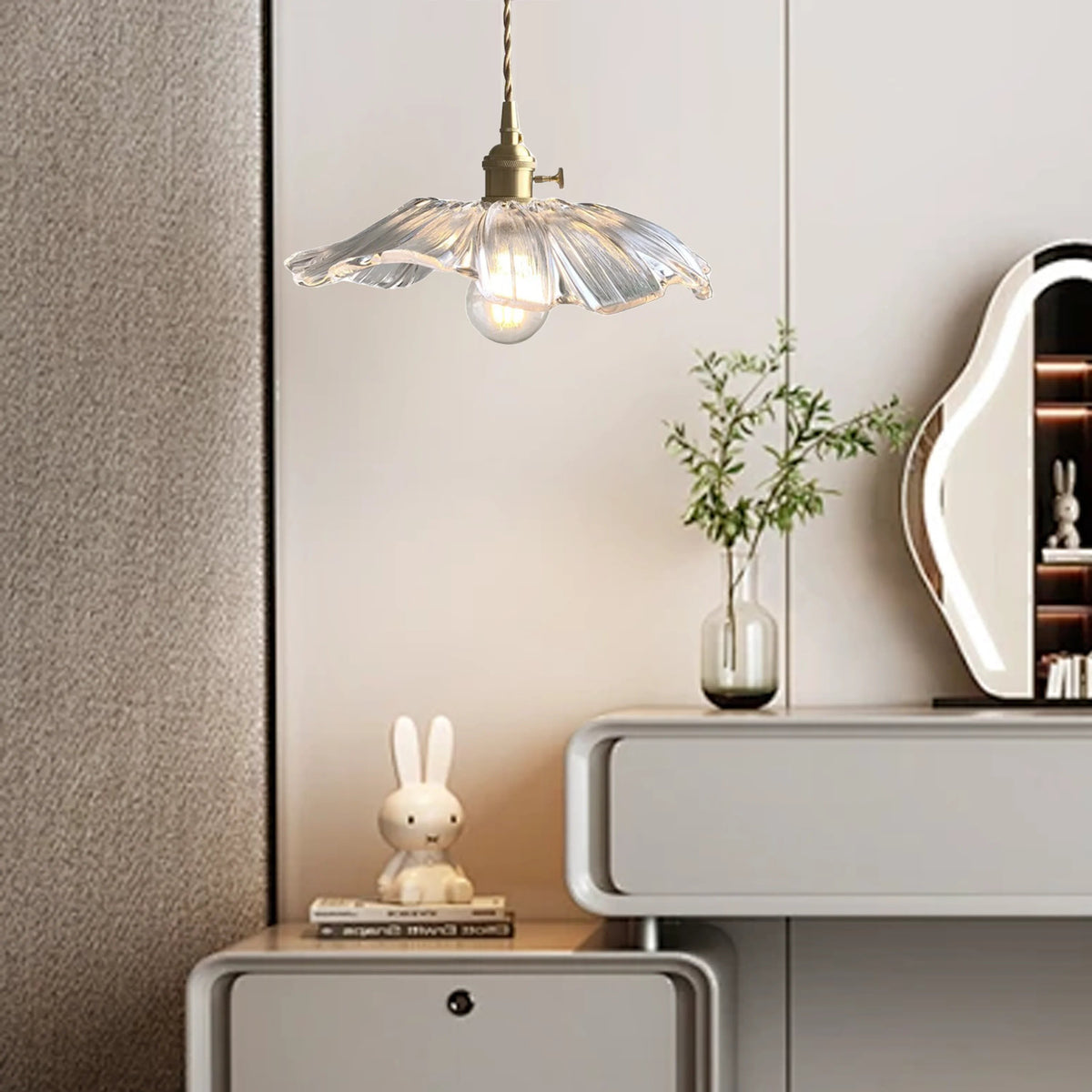 Clear lotus glass bila pendant used as elegant bedside lighting next to a modern cabinet