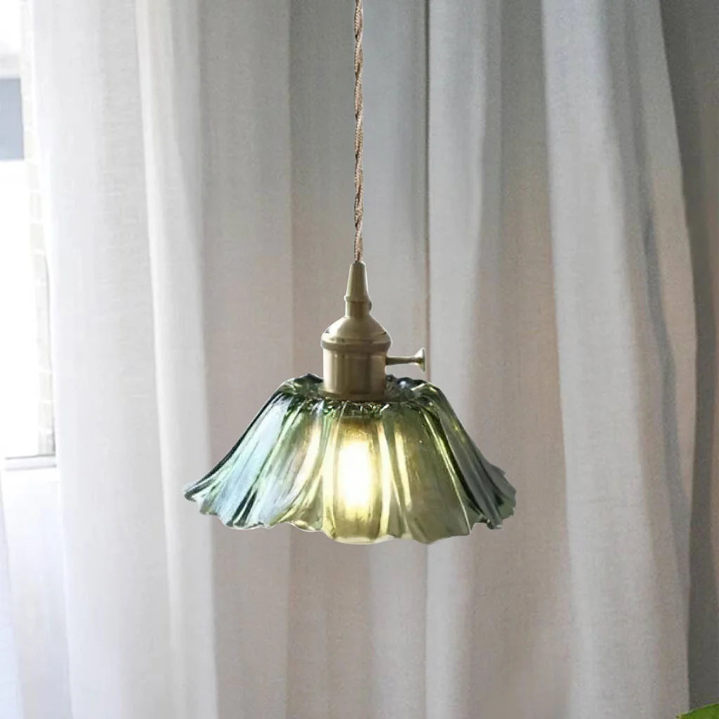 green bila scalloped glass pendant light hanging gracefully against a sheer white curtain