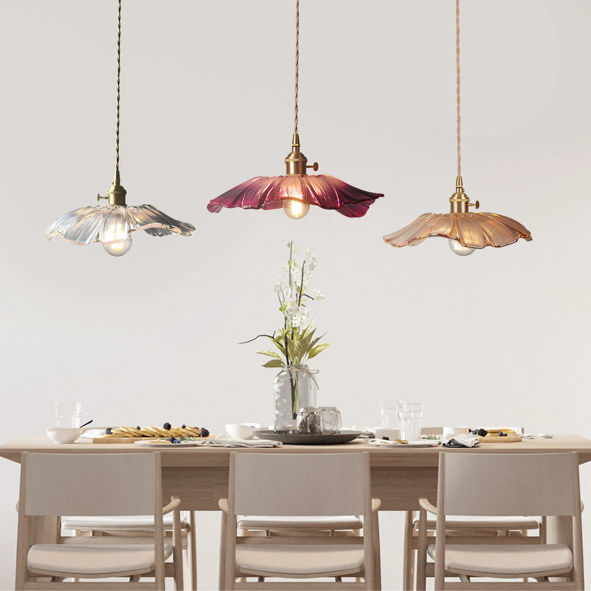 Mixed colour lotus glass bila pendant lights suspended elegantly over a modern dining table