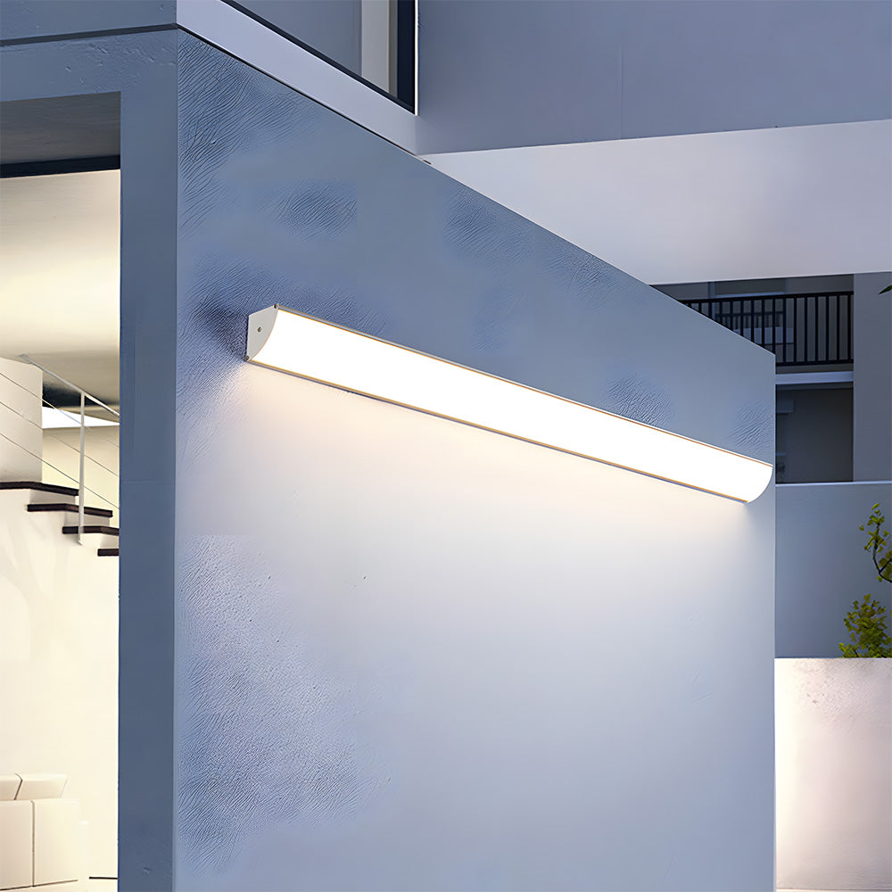 Angled close-up of a glowing front-lit linear bubce wall lamp showcasing its seamless acrylic diffuser