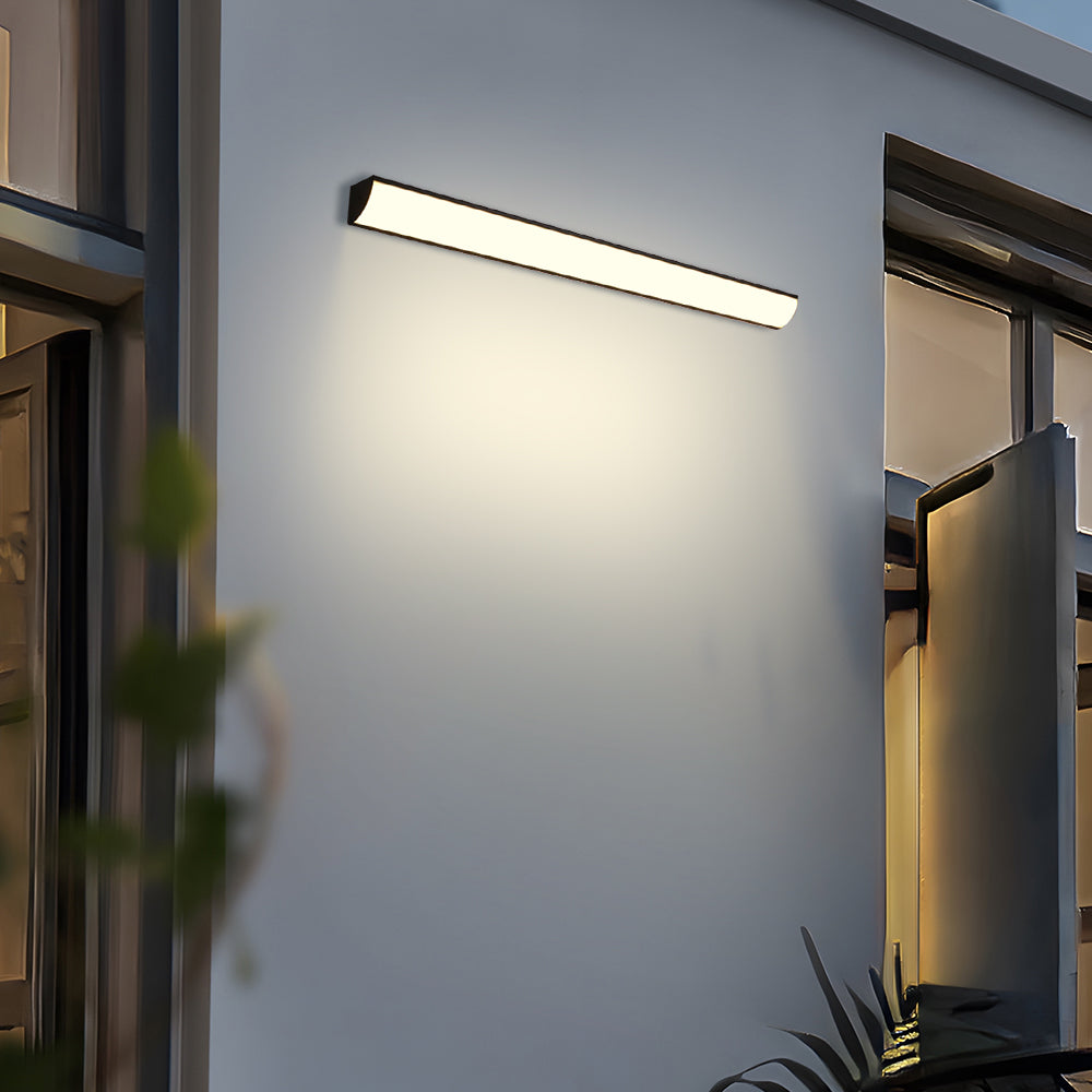 Front-lit exterior linear bubce lamp installed horizontally on a modern patio wall