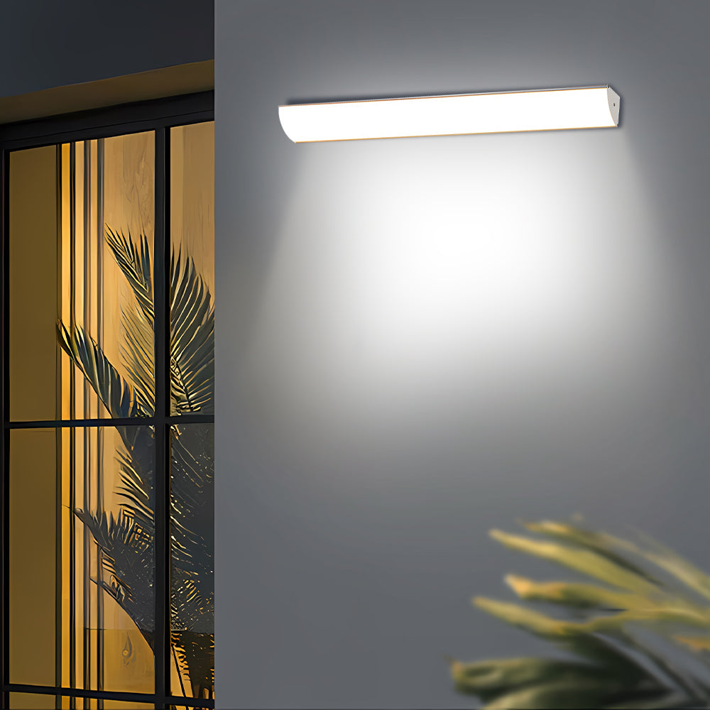 Bright linear LED bubce wall lamp highlighting the exterior near modern glass sliding doors