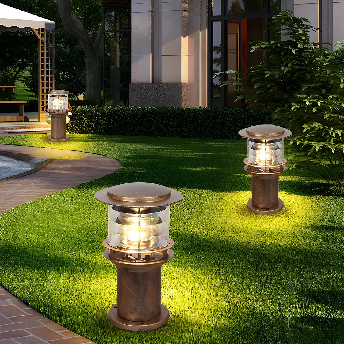 bulba two bronze solar garden pillars providing soft landscape lighting on a lush green lawn