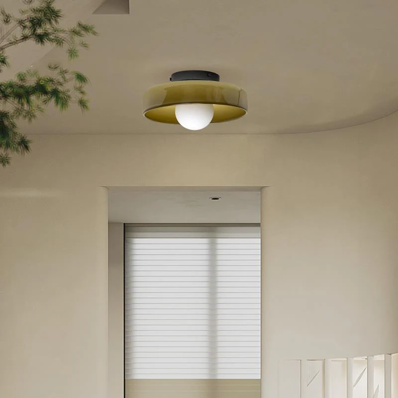 Olive green glass semi-flush mount cenas ceiling lamp illuminating a bright, neutral bedroom