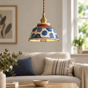 Cend Blue Daisy hand-painted ceramic pendant light, centered, in a modern British minimalist living room