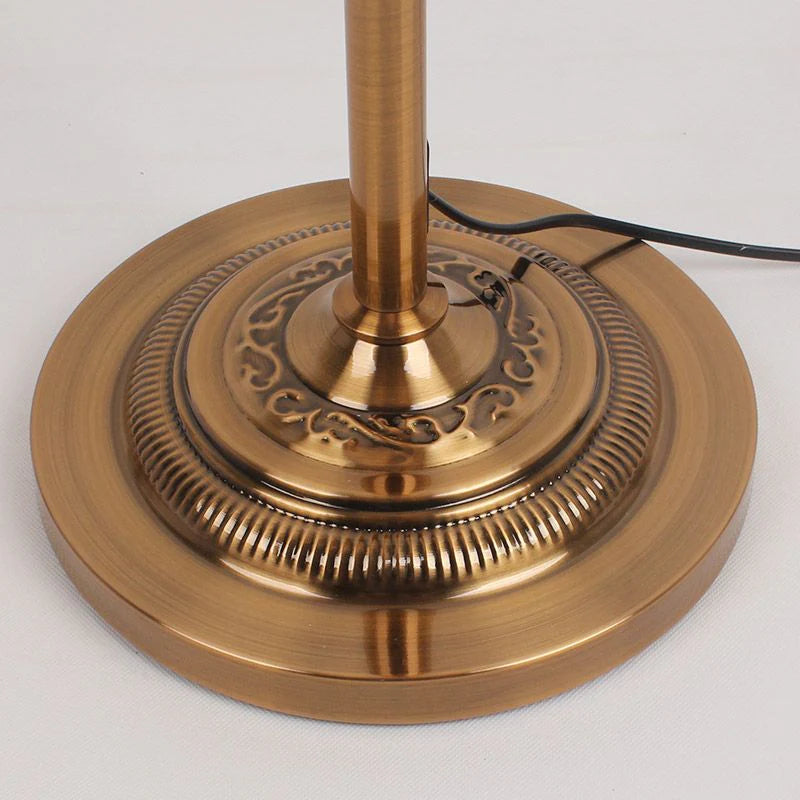 Close-up detail of the heavy, ornate antique brass finish cerf floor lamp base