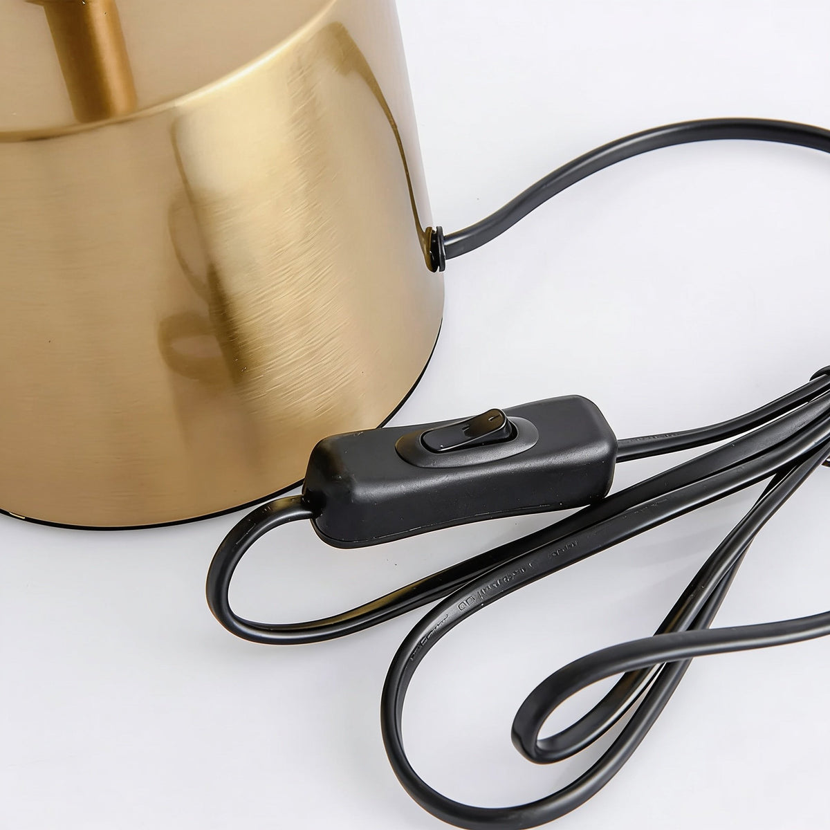 Close-up of the Elkon brass lamp base with its black inline on-off switch and cable