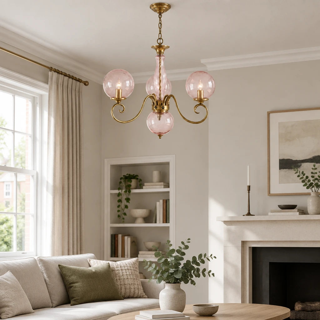 Elur brass-finish iron chandelier, Blush Pink hand-blown glass, close-up detail in a modern British minimalist living room