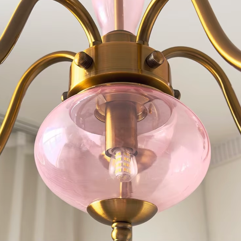Elur chandelier Blush Pink lower glass globe and brass-finish iron hub, close-up