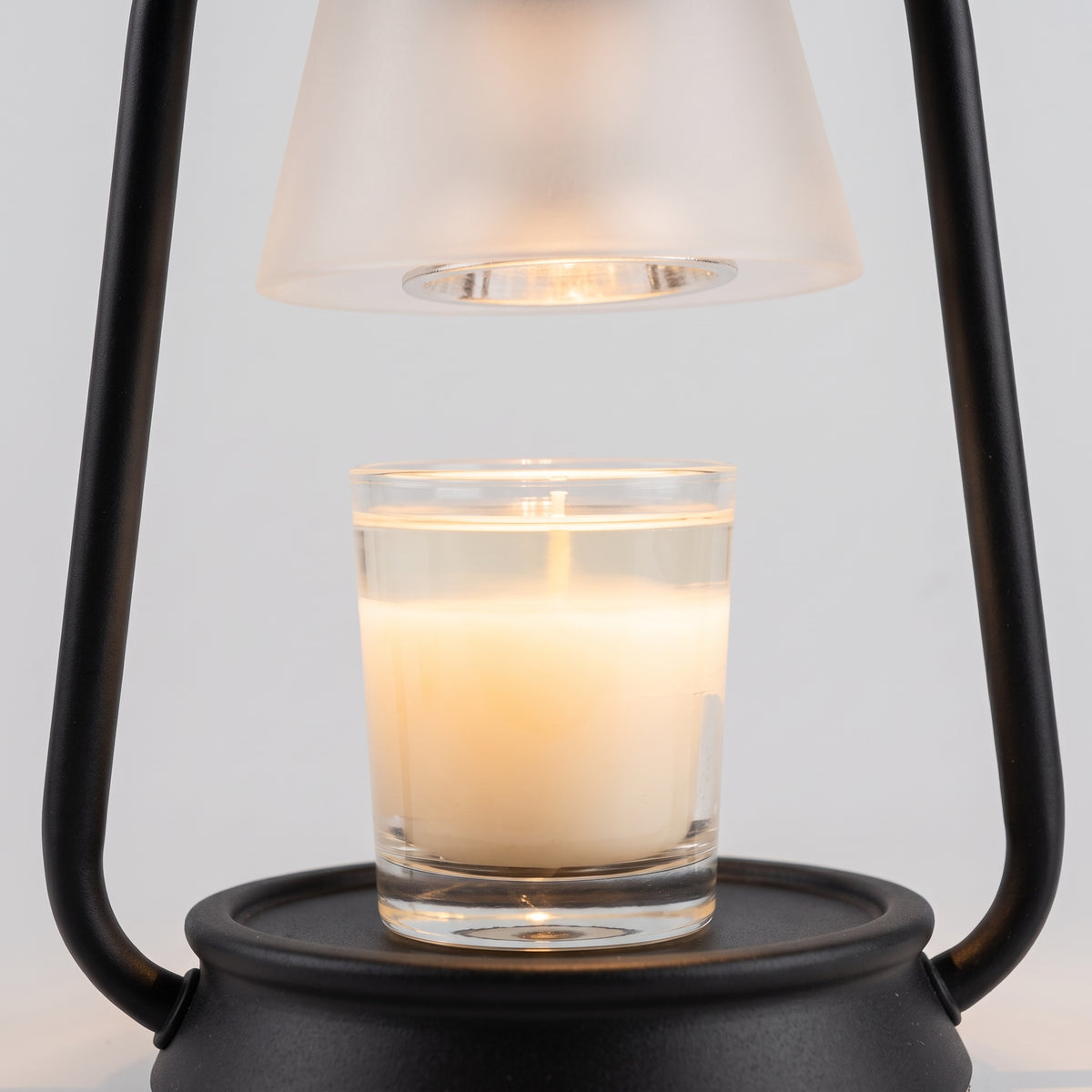 Embra black lantern candle warmer lamp warming a candle in a glass jar