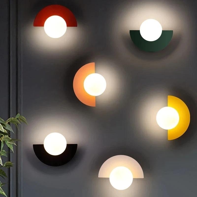 Dynamic cluster of colourful geometric fers wall sconces in white, orange, green, black, red, and yellow