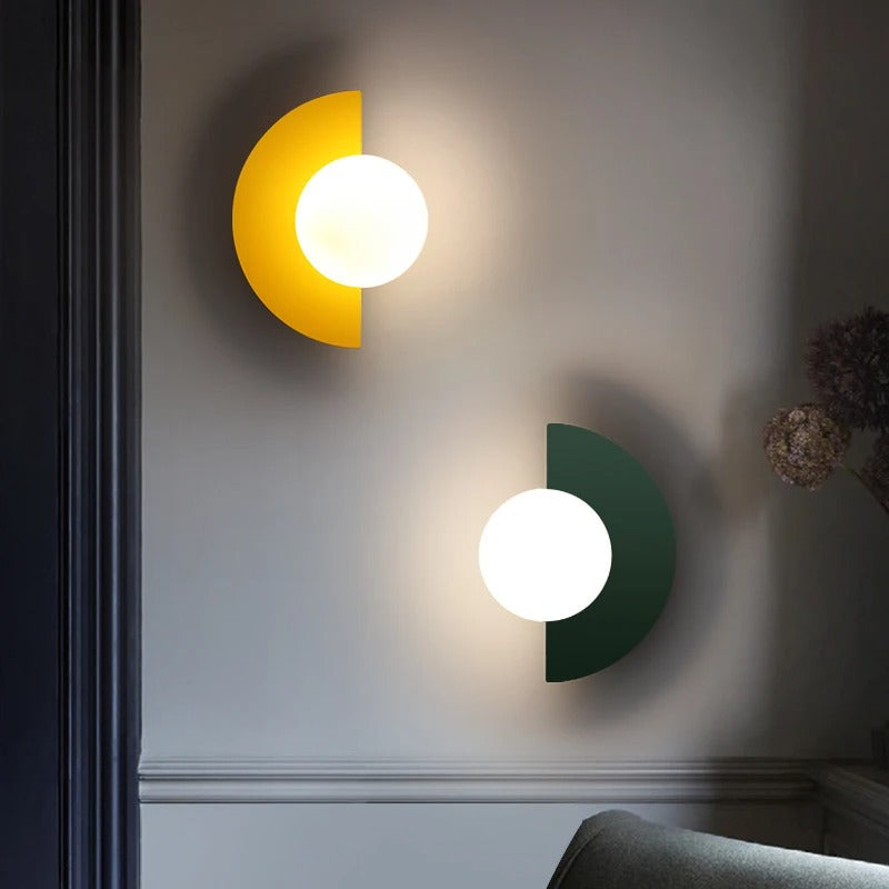 Yellow and green modern semi-circle fers wall lamps providing a playful pop of colour in a contemporary interior