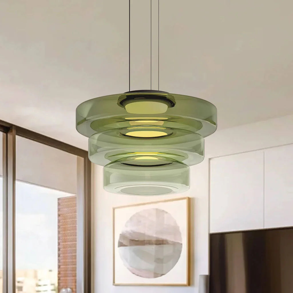 Green 3-layer Bauhaus fujs glass pendant light hanging against a neutral living room background