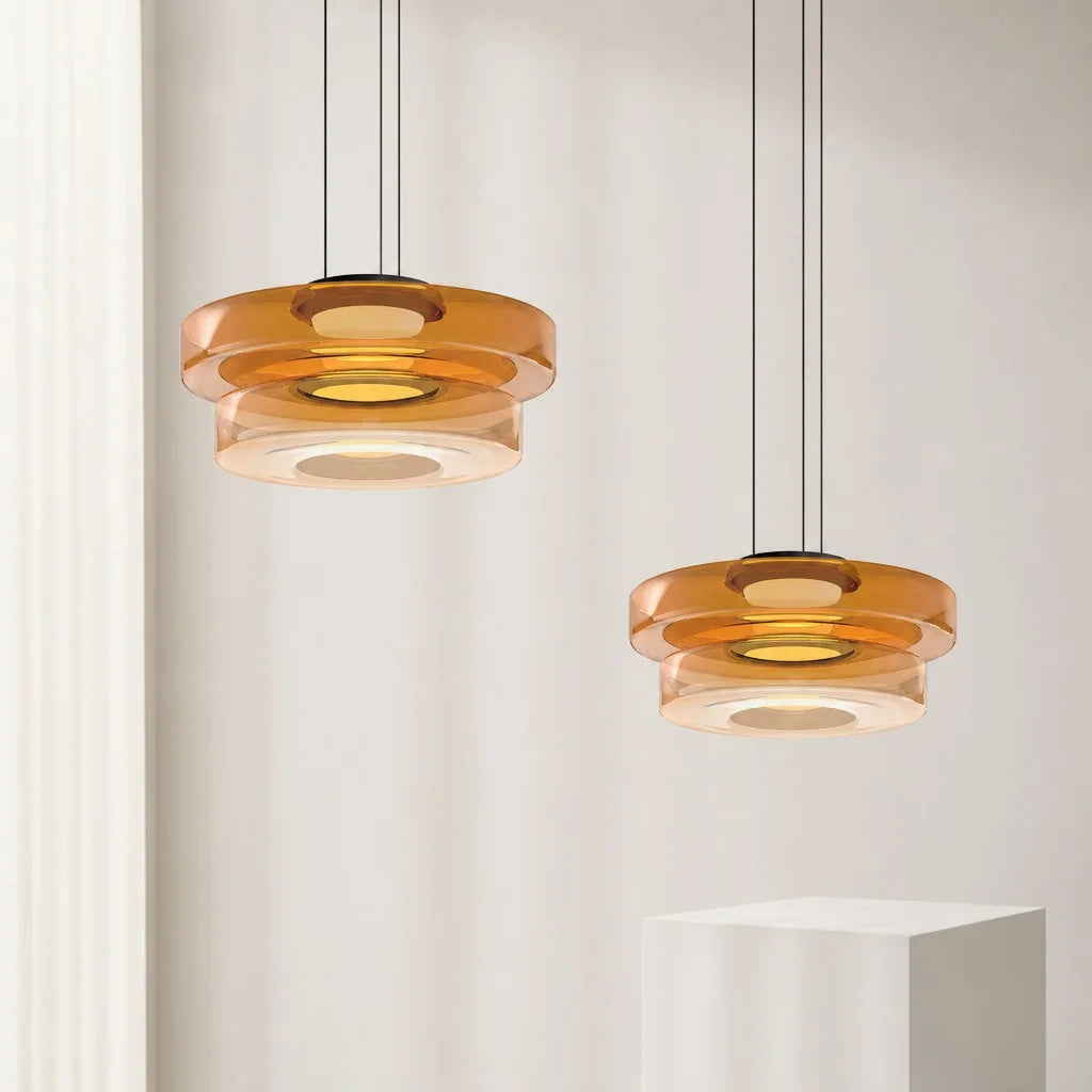 Pair of 2-layer amber fujs glass pendants suspended at varying heights for a layered modern look