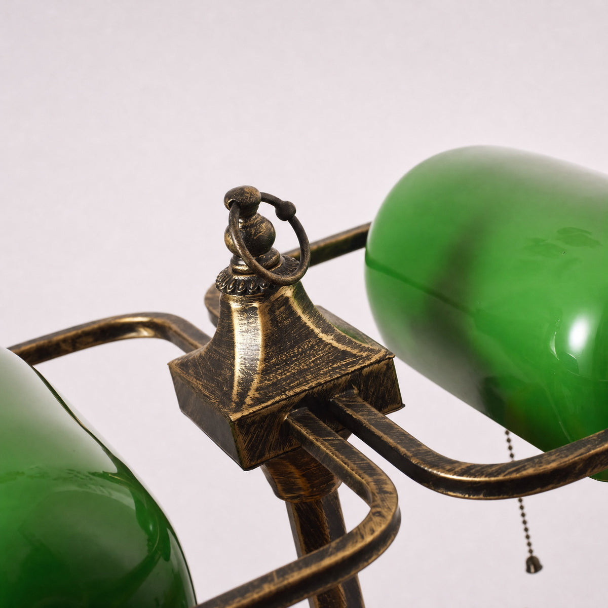 Gemma bankers lamp brass rails and green glass shade seen at close range