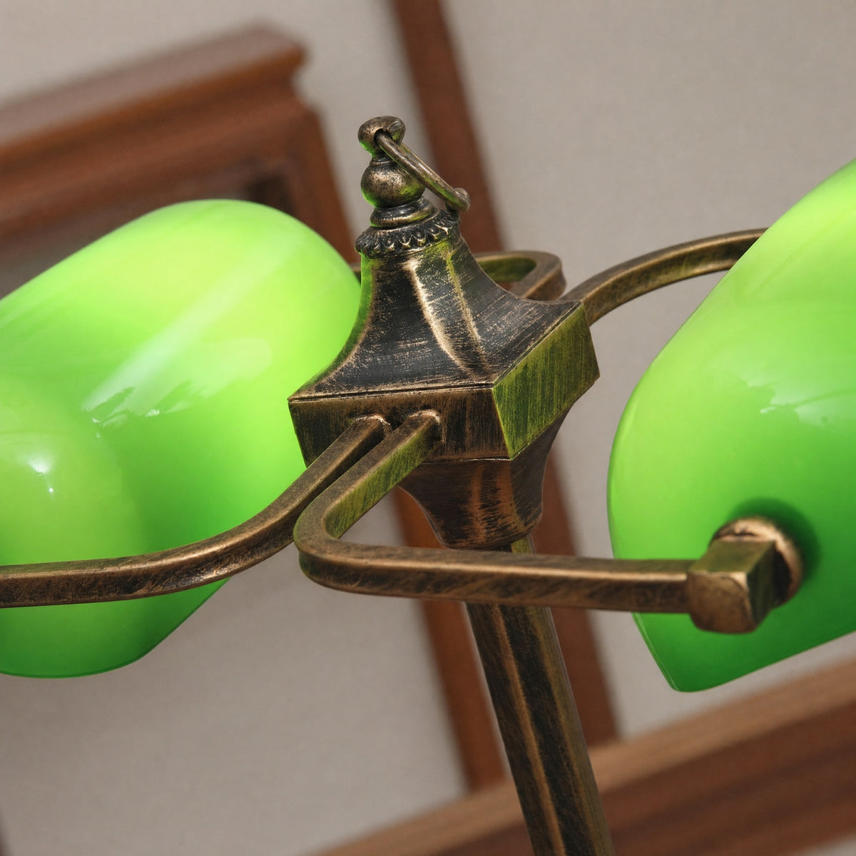 Close-up of the Gemma bankers lamp brass T-bar junction and green glass shades
