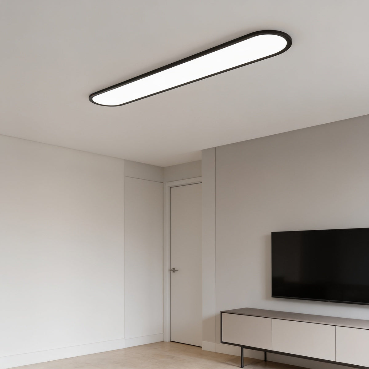 Grale black oval linear LED ceiling light in a living room with a TV unit