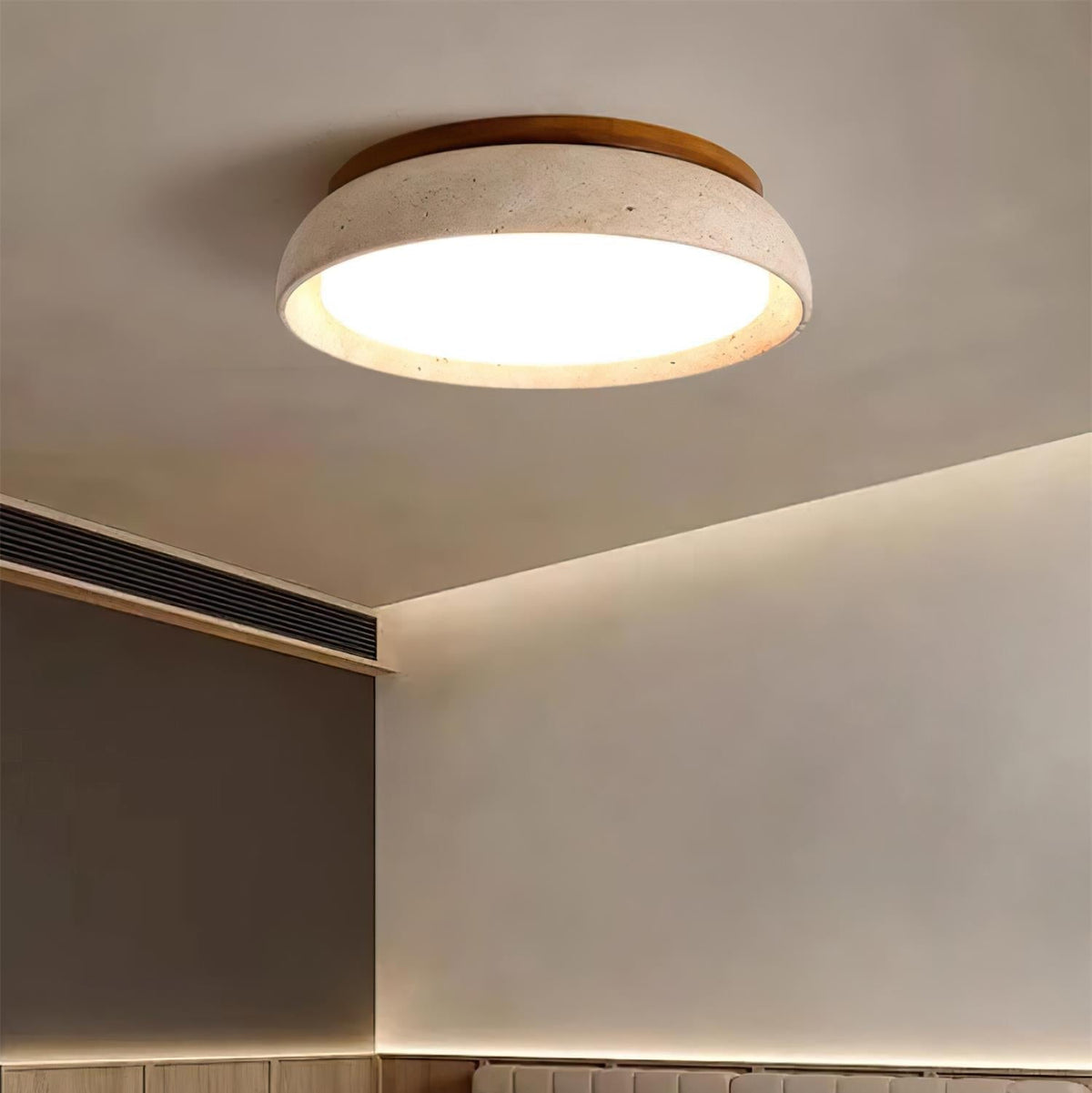 Organic stone flush mount gugs ceiling light providing warm ambience in a moody bedroom