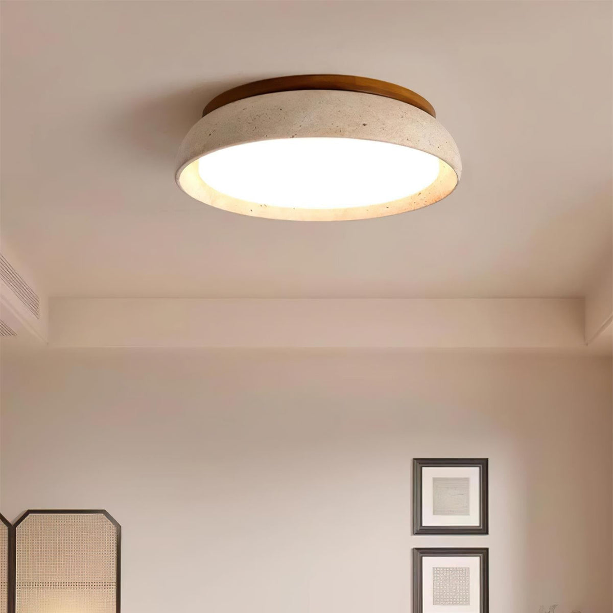 Round travertine gugs ceiling fixture in a serene Japandi style living room
