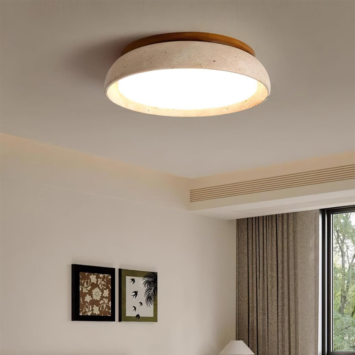 Travertine and wood LED gugs ceiling lamp illuminating a bright room with framed art