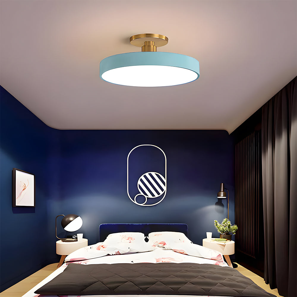 blue drum guoj ceiling light creating a striking focal point in a moody, dark blue bedroom