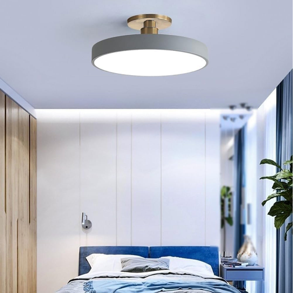 Grey round LED guoj ceiling light perfectly complementing a modern blue bedroom interior
