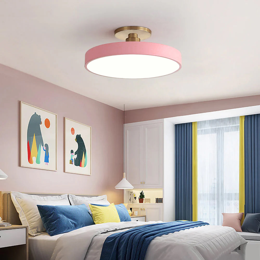 Pink pastel drum guoj ceiling lamp adding a playful pop of colour to a bright, modern bedroom
