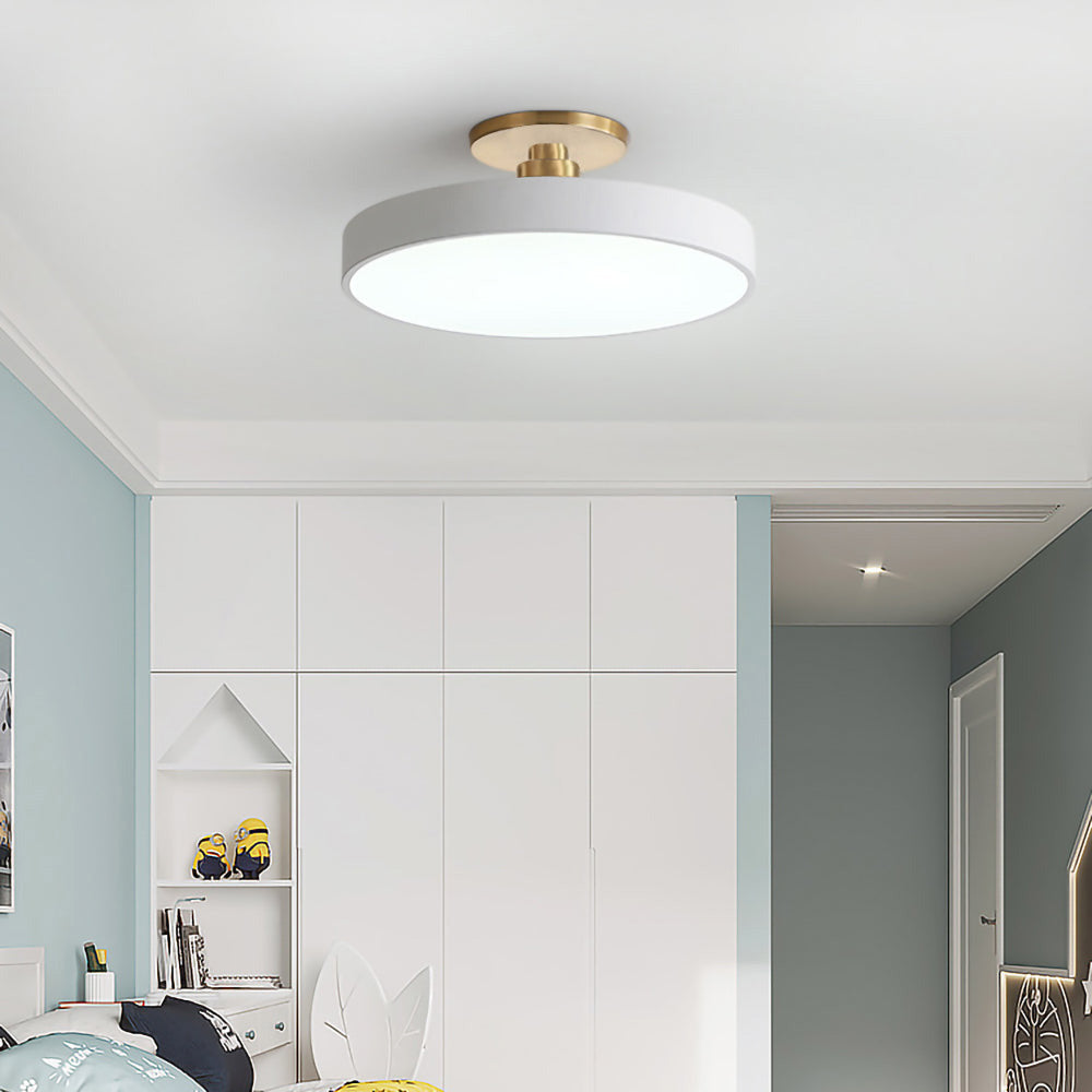 white circular guoj ceiling light providing bright, even illumination in a white walk-in wardrobe.
