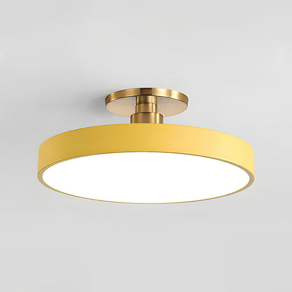 Vibrant yellow macaron drum guoj ceiling lamp isolated on a light grey background