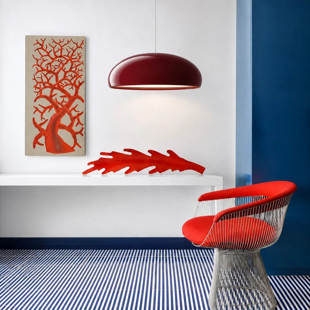 Vibrant red Bauhaus huhs pendant light acting as a striking focal point in a colourful modern interior