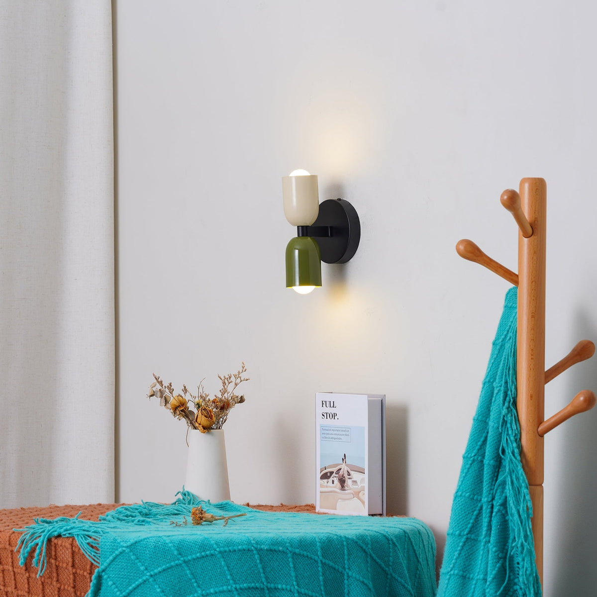 Mid-century hutre double-head glass wall sconce illuminating a bright entryway and coat rack