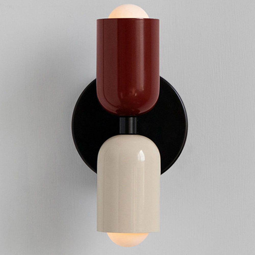 Red and beige hutre mid-century wall light featuring two glowing capsule shades