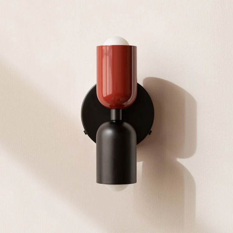 Red and black hutre double glass wall sconce offering a bold contemporary contrast