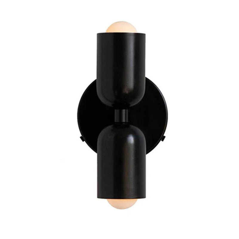 Solid black capsule hutre glass wall sconce for a sleek, monochromatic modern look