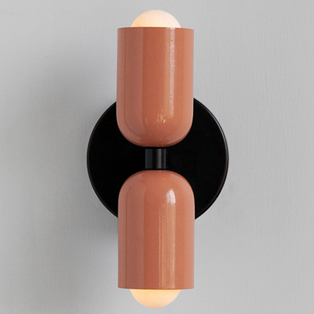 Solid pink hutre retro glass wall lamp with a sleek black central wall bracket