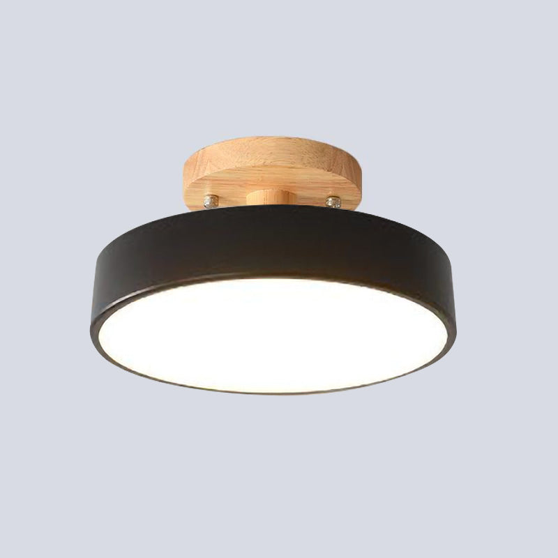 Isolated view of the bold black Nordic wood huty ceiling lamp with its glowing acrylic diffuser