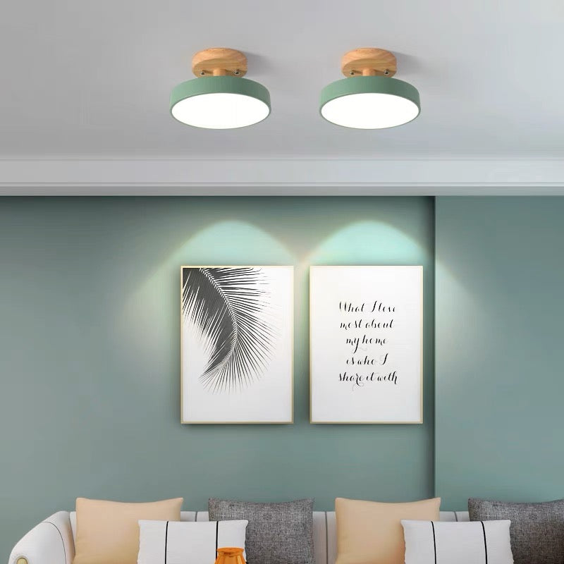 Two green macaron semi flush mount huty ceiling lights providing ambient lighting over a living room sofa