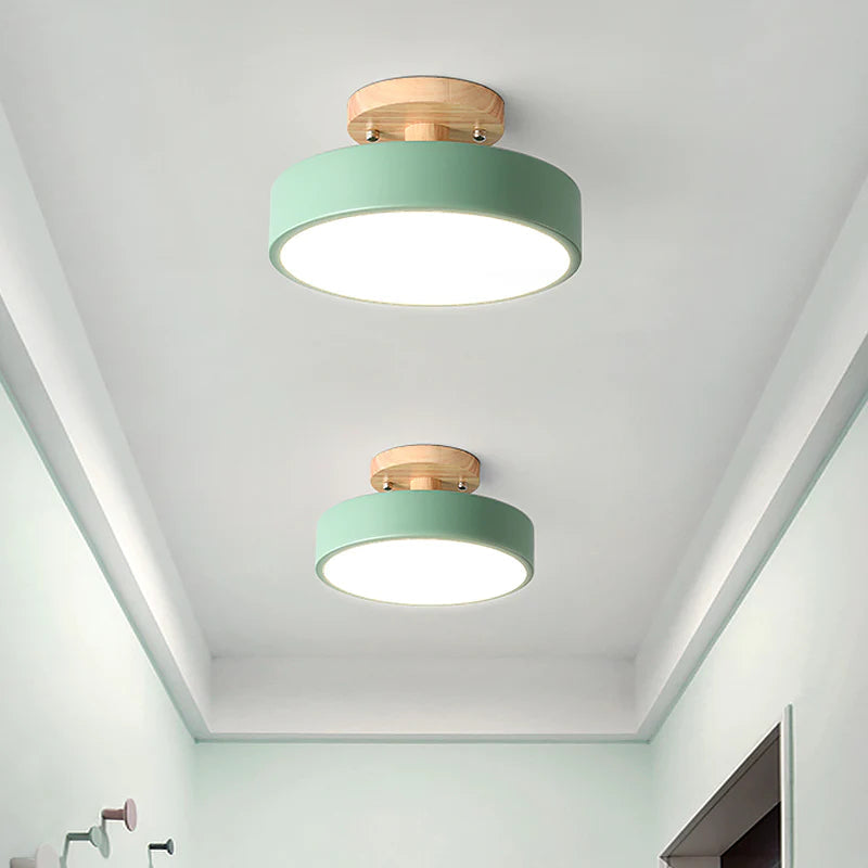Pair of green pastel huty ceiling lights illuminating a light green residential corridor