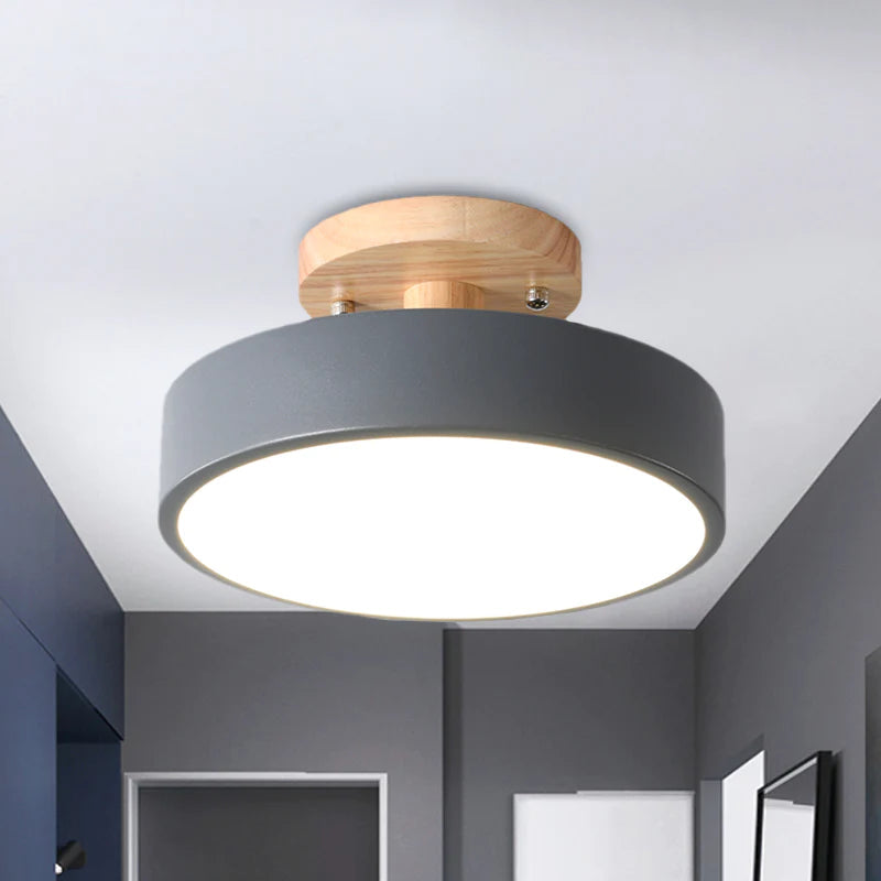Close-up of the grey metal and natural wood round huty ceiling fixture in a modern grey room