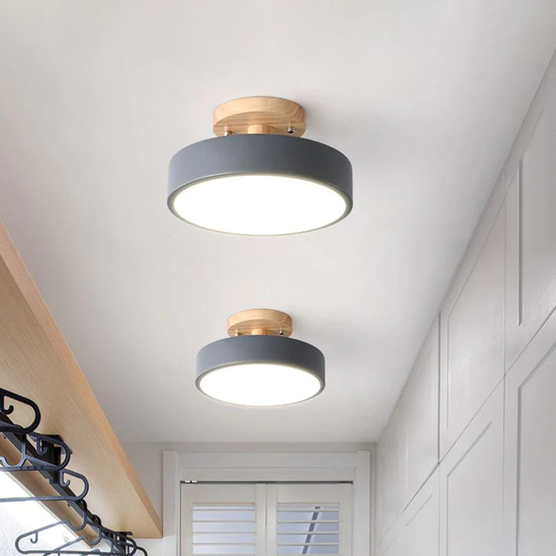Two grey modern semi flush mount huty ceiling lights illuminating a clean, white walk-in wardrobe