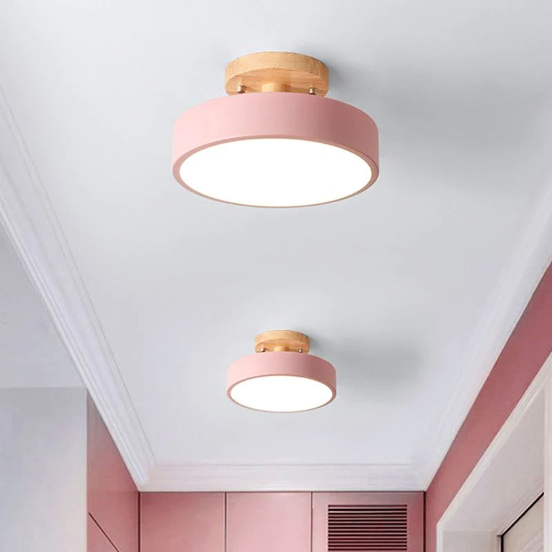 Pair of soft pink pastel macaron huty ceiling lights adding a playful touch to a bright hallway